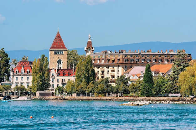 Chateau Ouchy at Lake Geneva quay in Lausanne, Switzerland. People on the background