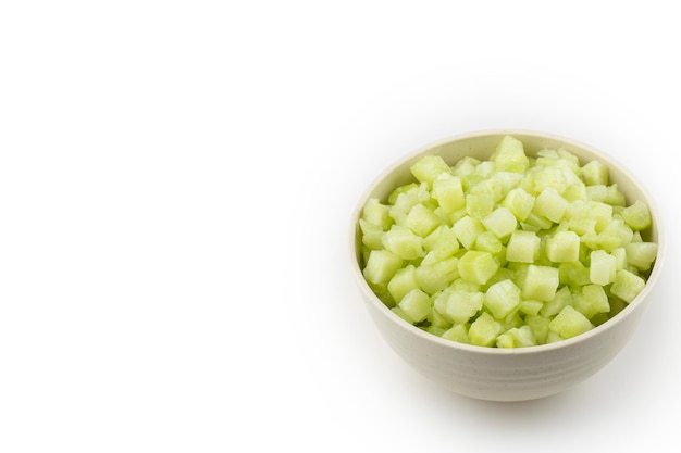 Chayote cubes in bowl isolated on white background