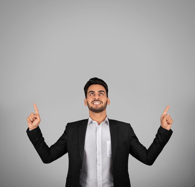 Check This Smiling Young Arab Businessman Pointing Up At Copy Space