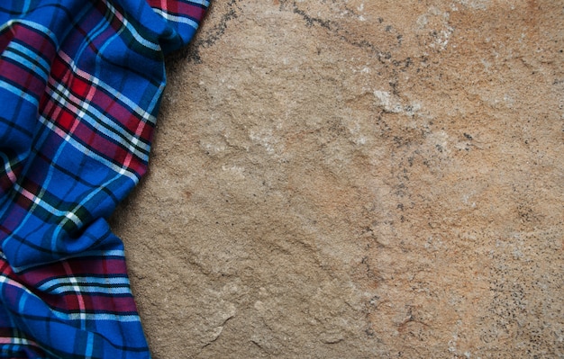 Checkered napkin on a stone surface