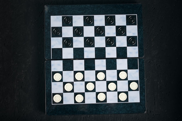 Checkers board with chips black background checkers logical board game