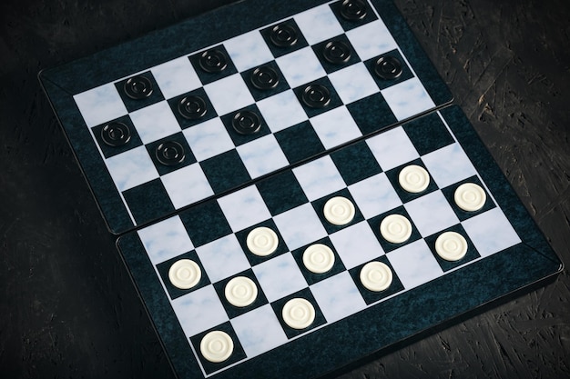 Checkers board with chips black background checkers logical board game