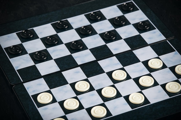 Checkers board with chips black background checkers logical board game