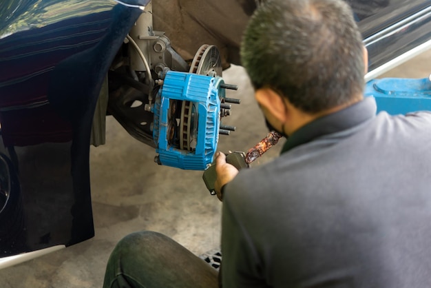 Checking car brake system for repair at car garage