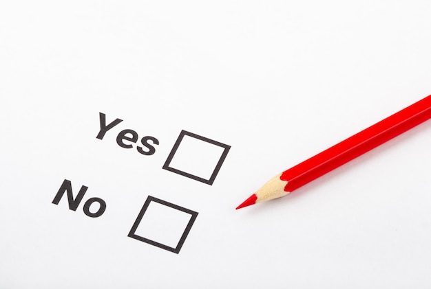 Checklist box with a pencil and word YES and NO on white paper