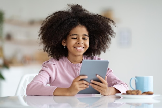 Cheerful african american girl having break while studying at home