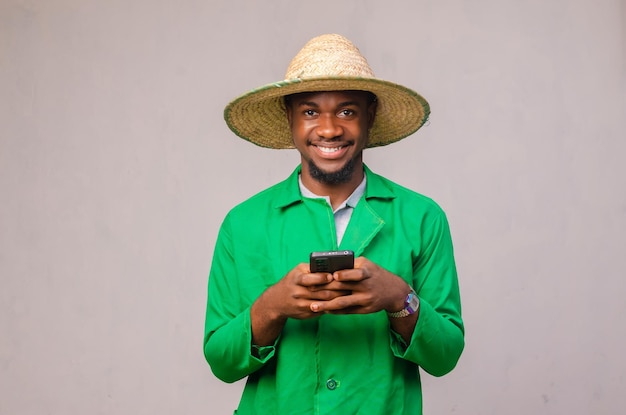 Cheerful African American man in white shirt using mobile phone application