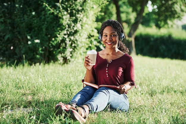 Cheerful african american woman in the park at summertime