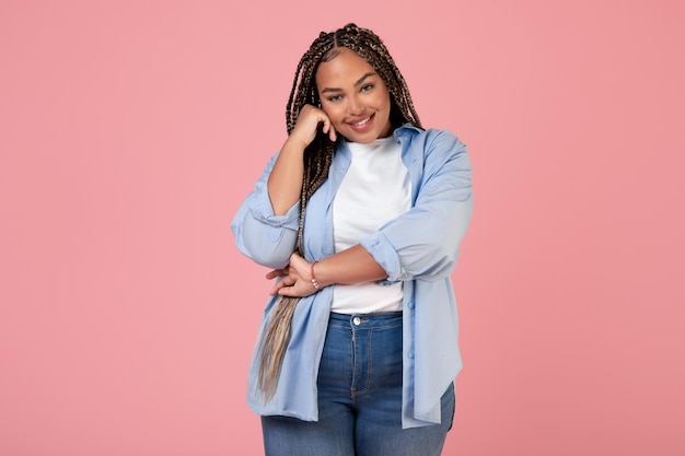 Cheerful Black Female Posing Touching Face Smiling On Pink Background