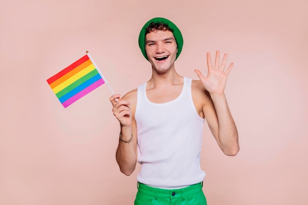 Cheerful boy holding rainbow flag