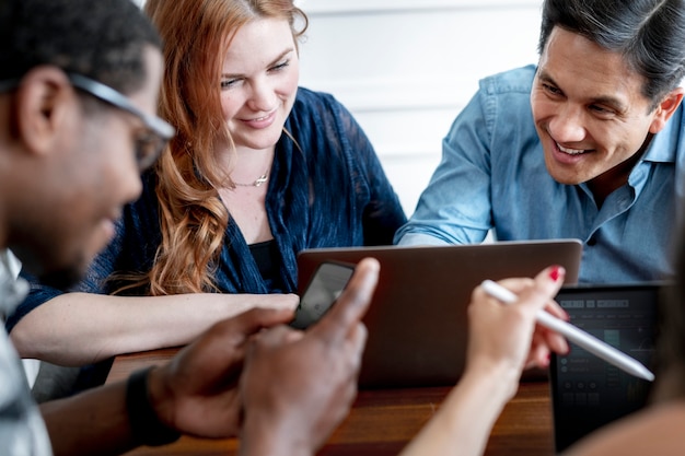 Cheerful business people using laptops at work