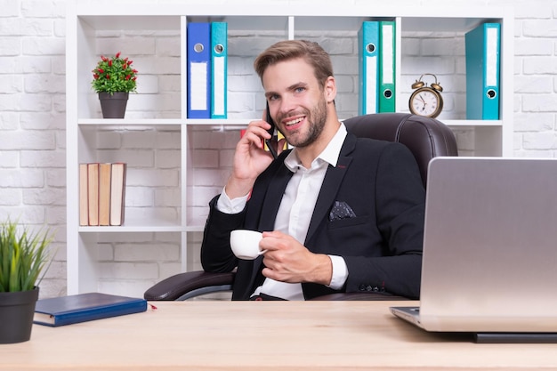 Cheerful businessman has phone talk on background photo of businessman has phone talk