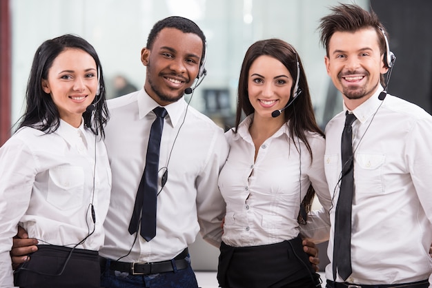 Cheerful call center workers, teamwork 