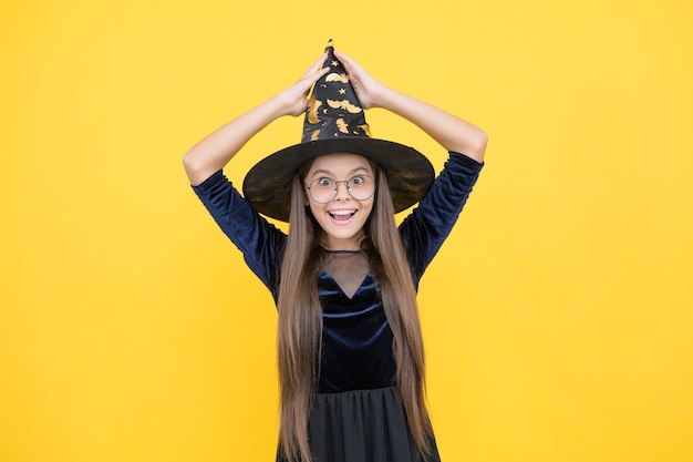 Cheerful child wear witch hat and glasses ready for enchantment on halloween happy halloween