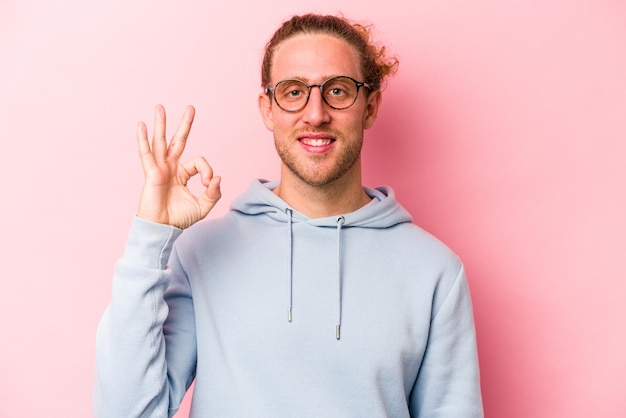 Cheerful and confident showing ok gesture