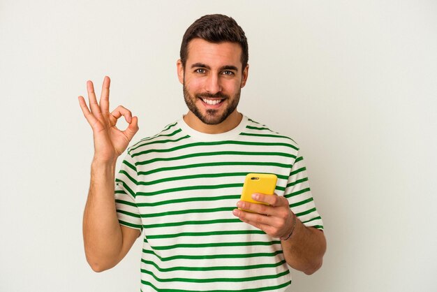 Cheerful and confident showing ok gesture