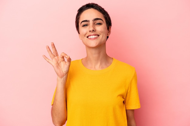 Cheerful and confident showing ok gesture