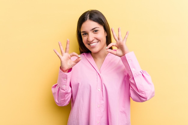 Cheerful and confident showing ok gesture