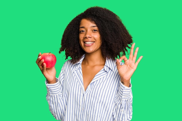 Cheerful and confident showing ok gesture