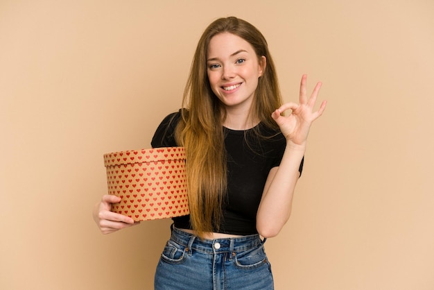 Cheerful and confident showing ok gesture