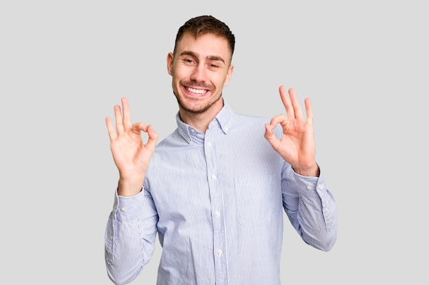 Cheerful and confident showing ok gesture