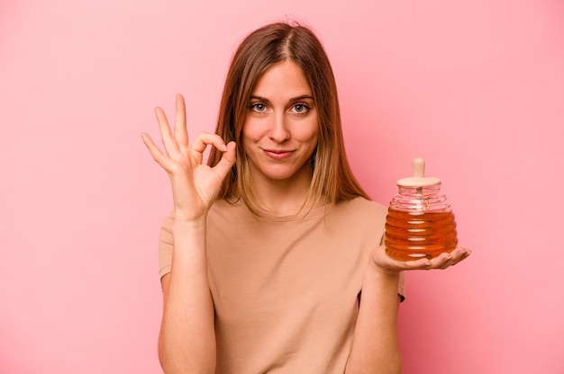 Cheerful and confident showing ok gesture