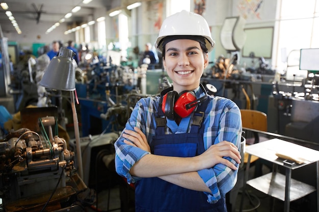 Cheerful confident woman at clock factory