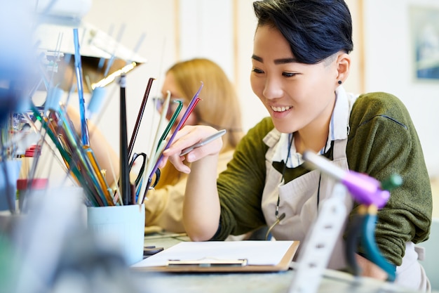 Cheerful Creative Woman in Workshop