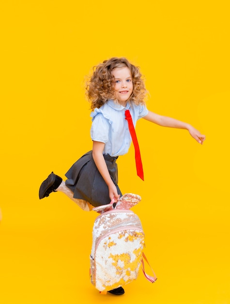 Cheerful cute genius positive little girl with curly hair 
