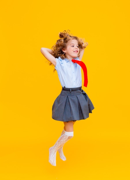 Cheerful cute genius positive little girl with curly hair 
