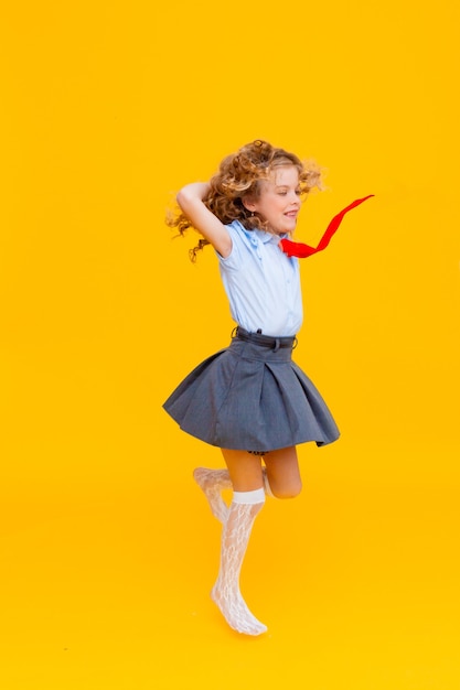 Cheerful cute genius positive little girl with curly hair 
