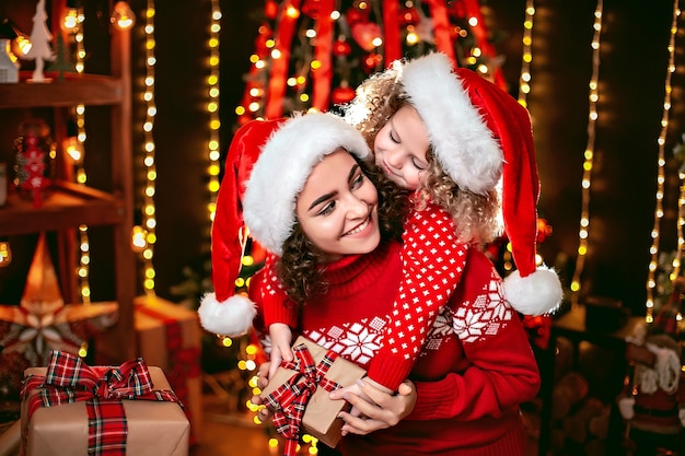 Cheerful cute little girl and her older sister exchanging gifts