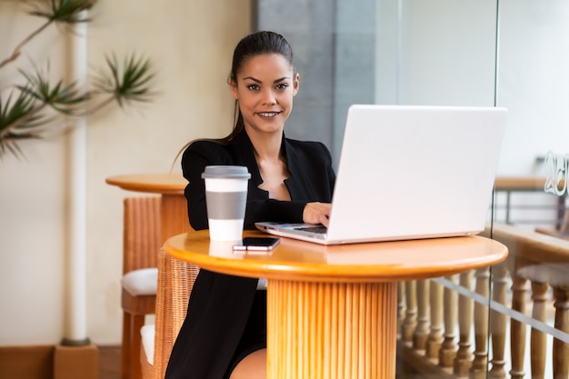 Cheerful elegant businesswoman with laptop