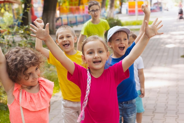 Cheerful emotional children having fun time outdoors