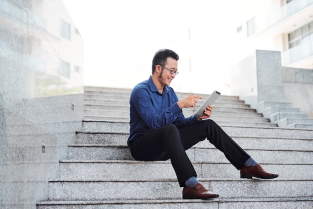 Cheerful entrepreneur with tablet computer