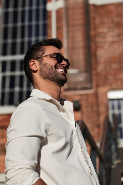 Cheerful ethnic man on street