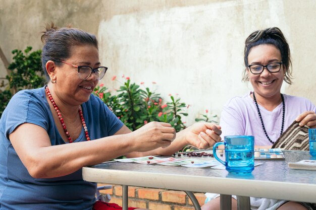 A cheerful family sits around a table smiling and spending time together