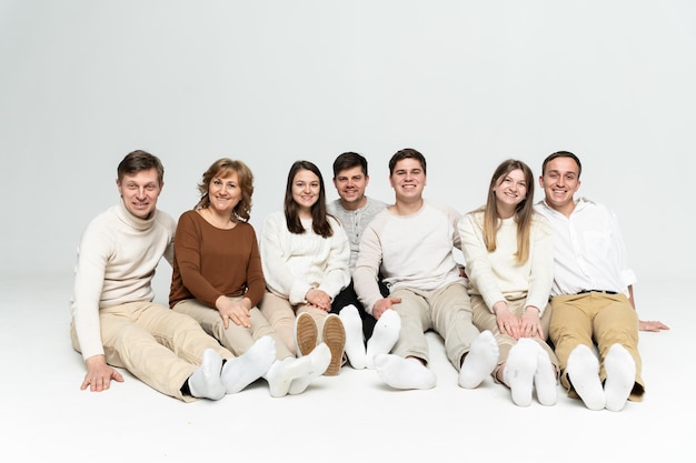 Photo cheerful family on a white background. people of different ages and nationalities. family members. group portrait on white background