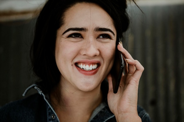 Cheerful female carpenter talking on a phone