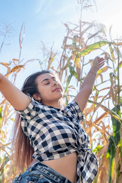 Cheerful female caucasian woman in the corn crop