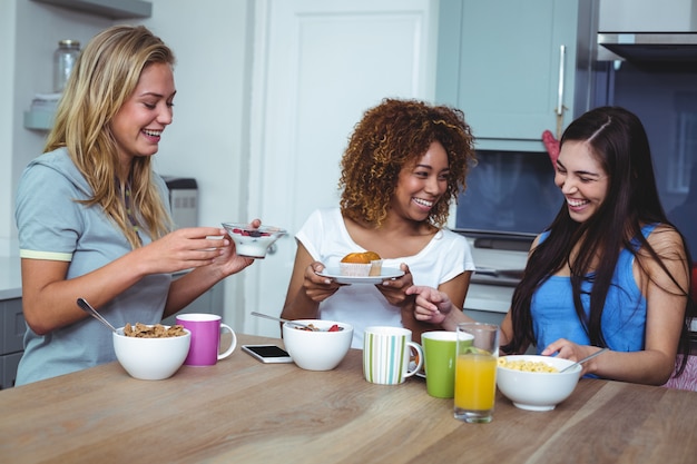 Cheerful female friends having food 