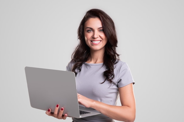 Cheerful female manager using laptop