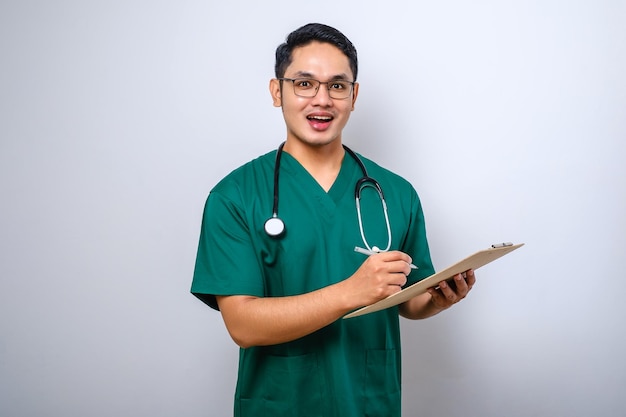 Cheerful friendly asian male physician doctor with clipboard during daily checkup