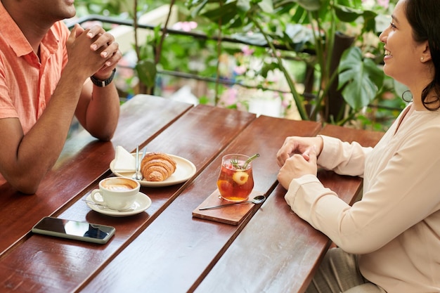 Cheerful Friends Sitting at Cafe Table