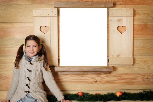 Cheerful girl in front of wooden background