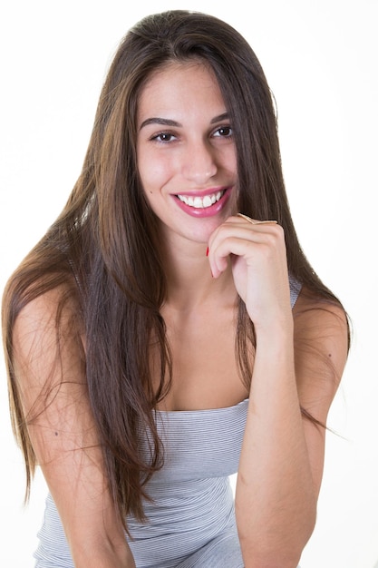 Cheerful girl hand under chin on white background in portrait shot