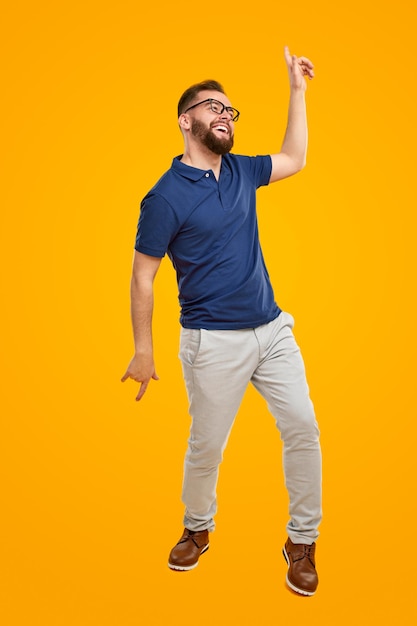 Cheerful guy dancing in studio