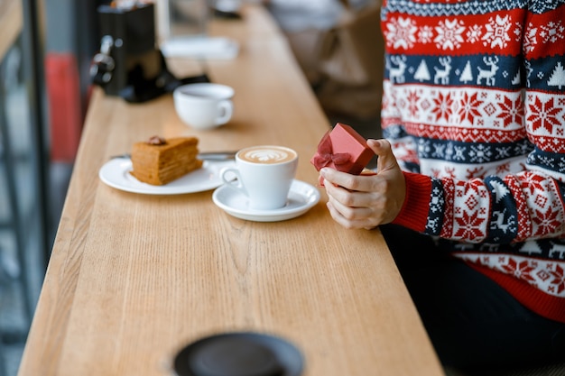 Cheerful happy and beautiful caucasian lady is resting in a cozy cafe terace