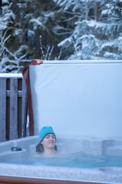 Cheerful happy company of teenagers enjoys hot bath on cold winter day Carefree relaxation in hot