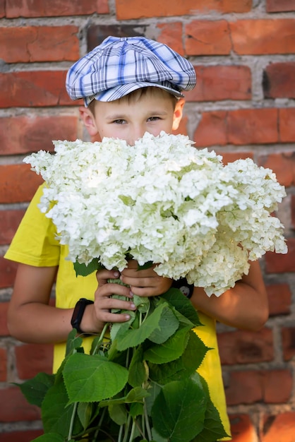 Cheerful happy village child with a bouquet of flowers